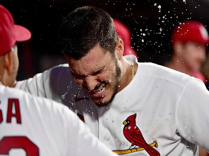 Jun 25, 2021; St. Louis, Missouri, USA; St. Louis Cardinals third baseman Nolan Arenado (28) is splashed with water by shortstop Edmundo Sosa (63) after hitting a solo home run during the third inning against the Pittsburgh Pirates at Busch Stadium.